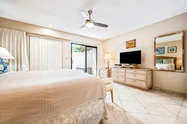 Bedroom features king bed ceiling fan dresser and views