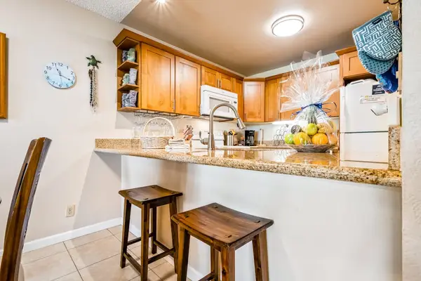 Fully equipped kitchen offers generous counters island seating and lighting