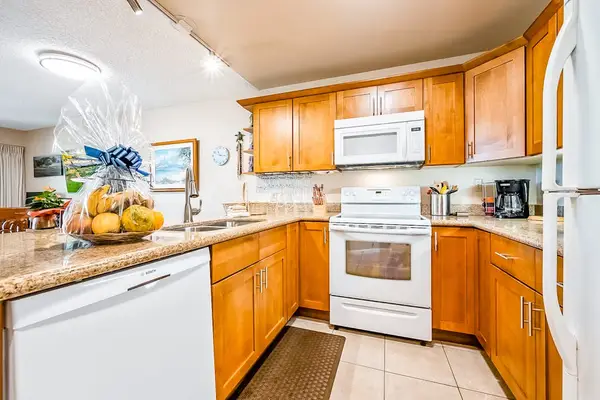 Kitchen appliances and wood cabinetry create welcoming meal preparation space