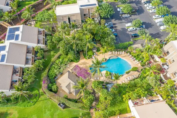 Aerial view showcases Maui Kamaole pool gardens and tropical grounds
