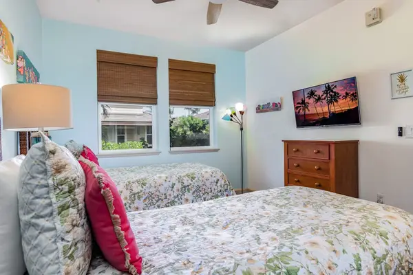 Comfortable Twin Bedroom Equipped with Wall-Mounted Flat-Screen TV