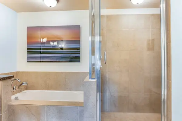 Walk-In Glass Shower and Separate Soaking Tub in Primary En-Suite