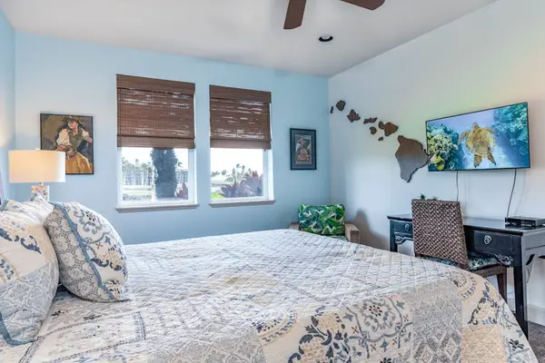 Bright Primary Bedroom with Flat-Screen TV and Dedicated Workstation