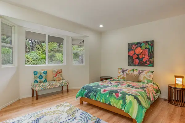 Vibrant Guest Bedroom with Tropical Bedding & Garden Views