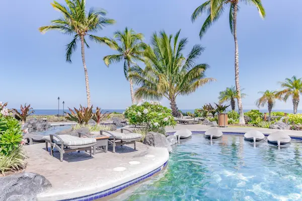 Resort-Style Swimming Pool surrounded by Tropical Palms