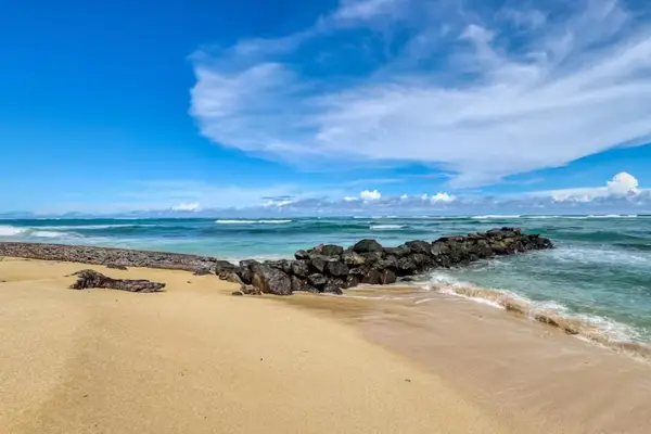 Beachfront Shoreline with Calm Water & Rock Breakwater