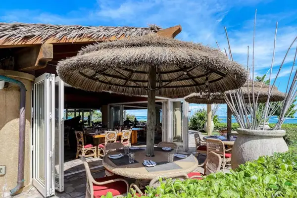 Tropical Outdoor Patio Seating with Thatched Tiki Umbrella
