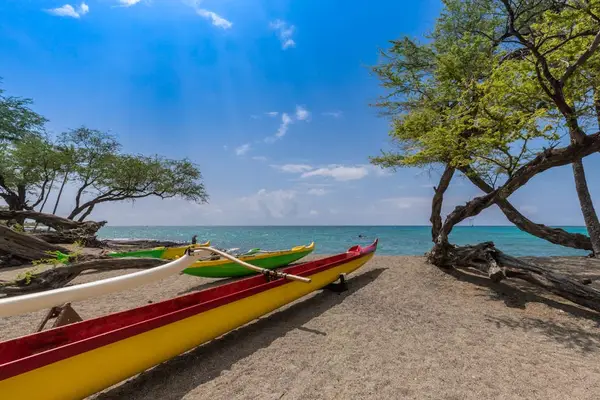 Nearby Sandy Beach with Outrigger Canoes