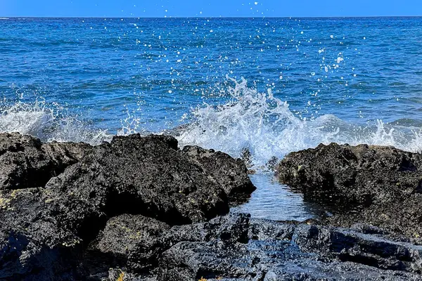Waves Crashing Along Lava Shores
