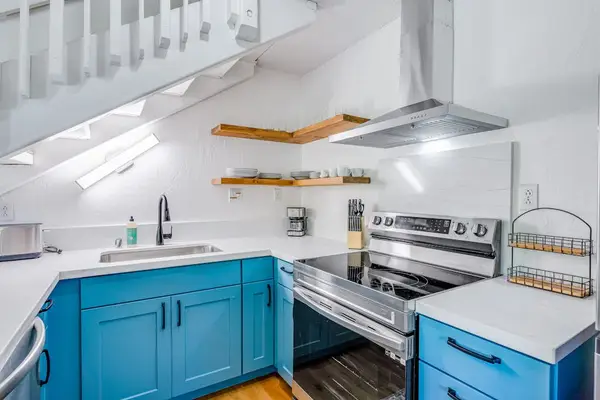 Modern Coastal Kitchen With Blue Cabinetry
