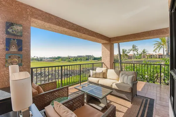 Balcony seating overlooks fairways, palms, furniture, railings, and evening skies