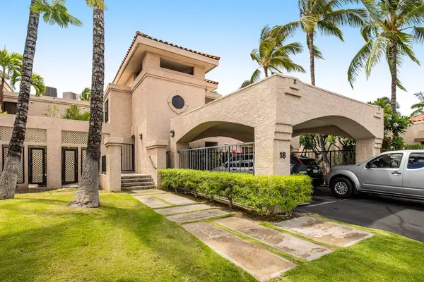 Resort entrance showcases architecture, palms, pathways, landscaping, and parking area