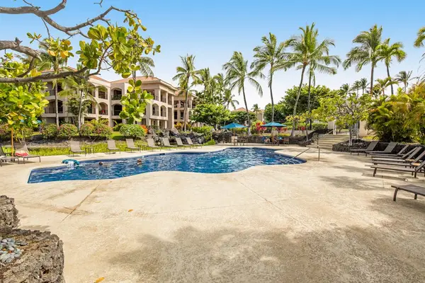 Pool view includes water, palms, loungers, umbrellas, buildings, and pathways