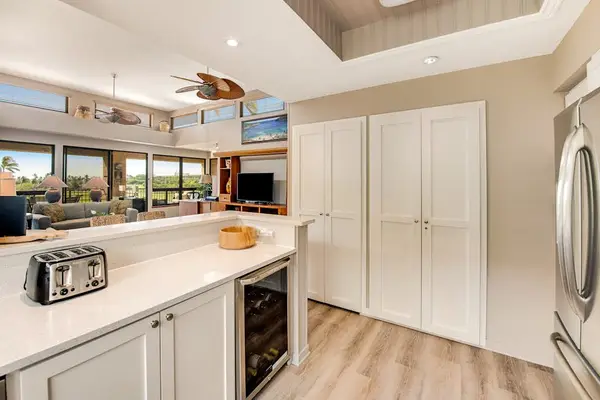 Kitchen connects counters, appliances, cabinetry, windows, dining, and living areas