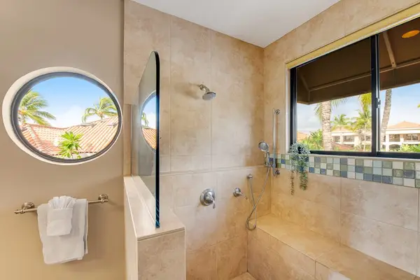 Full Bathroom includes walk-in shower, vanity, mirror, tilework, and lighting