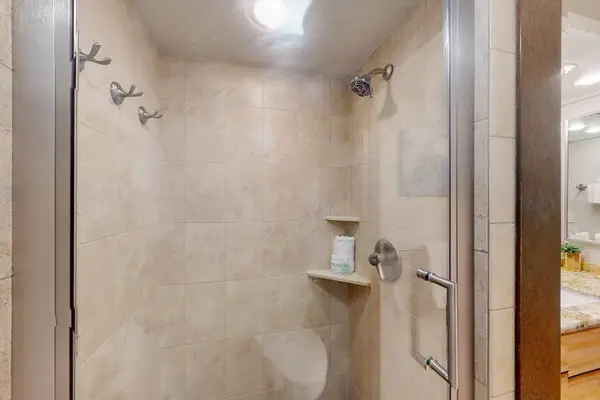 Refresh in the beautifully tiled walk-in shower after a day at the beach.