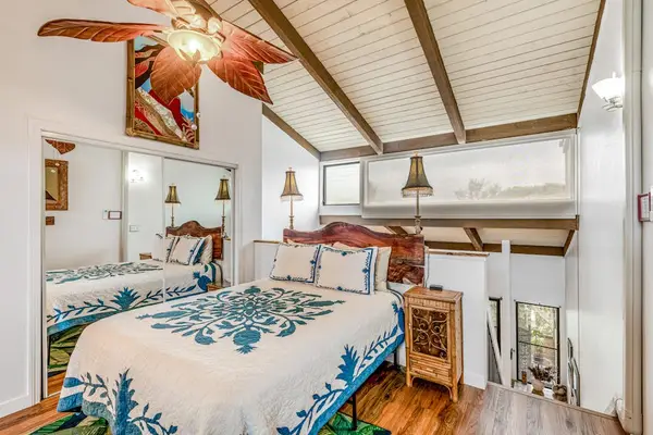 Airy Bedroom Beneath Vaulted Ceilings