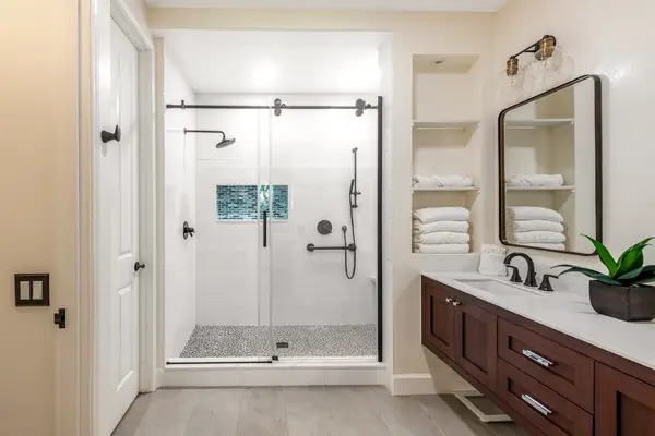 Master bathroom with double sinks and an updated walk-in shower.