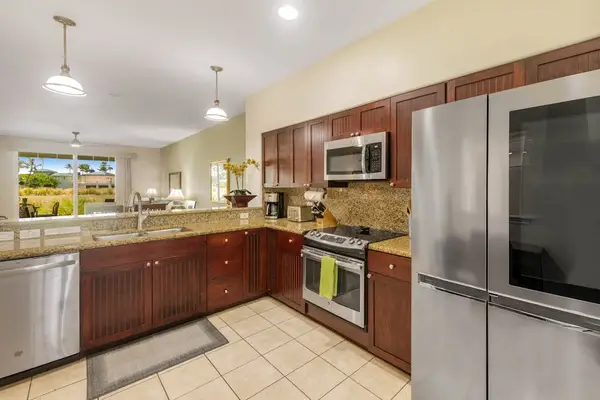 Large open air kitchen with new stainless steel appliances.