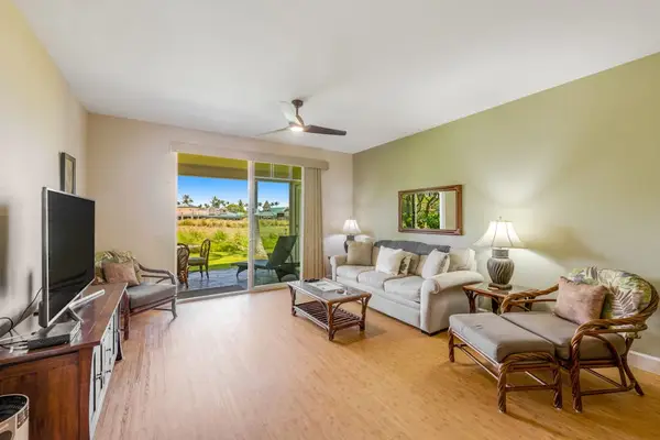 Large living room with a sofa bed, flat screen tv and lanai access.