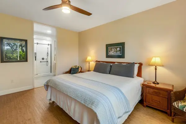 Master bedroom with king bed, flat screen tv and an en-suite bathroom.