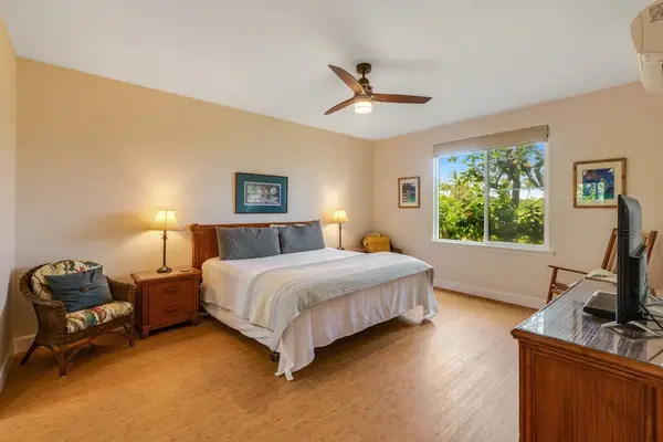 Master bedroom with king bed, flat screen tv and an en-suite bathroom.