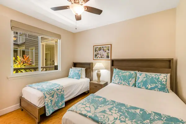 Guest room with queen bed, twin bed and a flat screen tv.