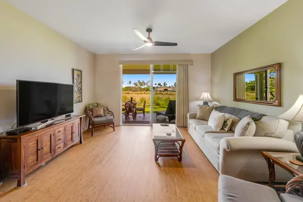 Large living room with a sofa bed, flat screen tv and lanai access.
