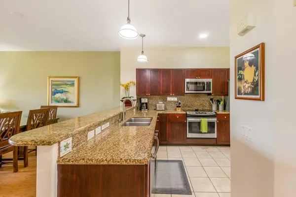 Large open air kitchen with new stainless steel appliances.