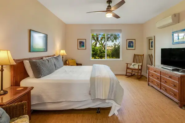 Master bedroom with king bed, flat screen tv and an en-suite bathroom.