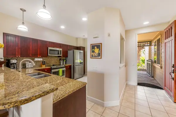 Large open air kitchen with new stainless steel appliances.