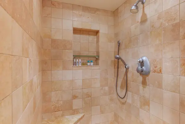 Spacious walk-in shower with tile finishes