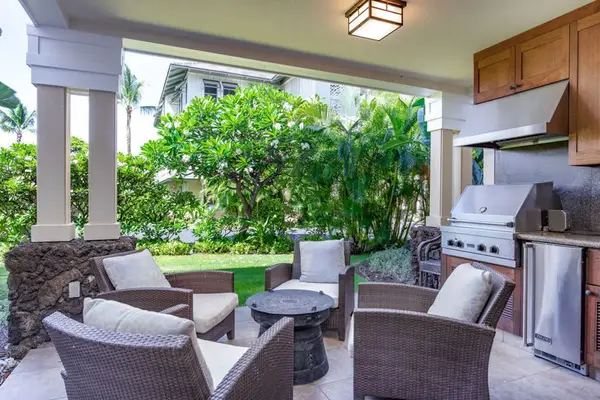 Covered lanai with outdoor seating and BBQ grill