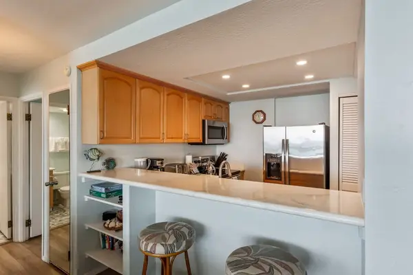 Kitchen counter with barstools for extra seating.