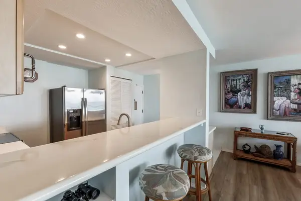 Kitchen counter with barstools for extra seating.