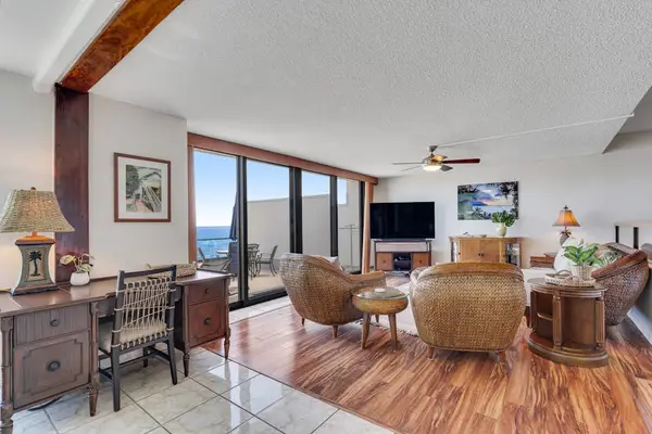 Comfortable living room featuring warm island décor and direct access to the ocean-view lanai