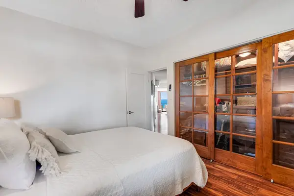 Primary bedroom with a custom closet, spacious and full of natural light