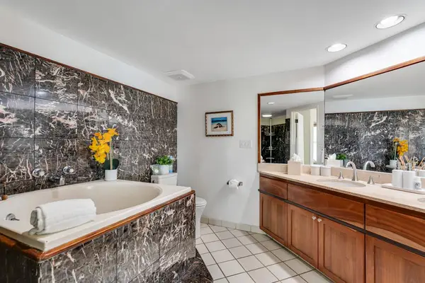 Primary en-suite with a soaking tub, perfect for unwinding after the beach
