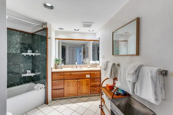 Ensuite bathroom with rain shower, designed to relax after a day at the beach