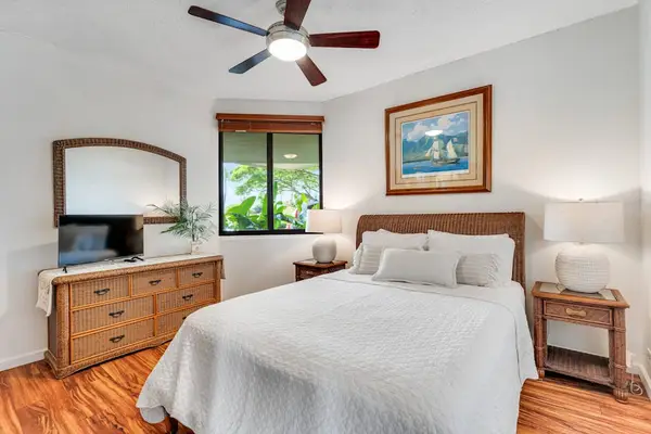 Guest bedroom to rest comfortably, with garden views and natural wood accents