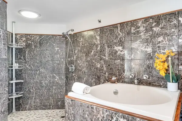 Primary en-suite with jetted tub and rain shower, ideal for total relaxation