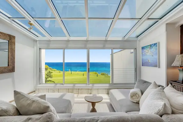 Bright sunroom with panoramic ocean views—perfect for your morning coffee or a relaxing afternoon