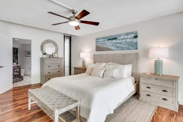 Primary bedroom with elegant décor and coastal art touches