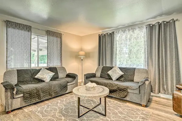 Lovely open living room with large floor to ceiling windows.