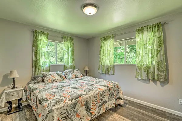 Master bedroom with king bed and lots of natural light from the windows.