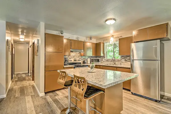Upgraded kitchen with stainless steel appliances and a lovely island.  Barstools at the kitchen island for extra seating.