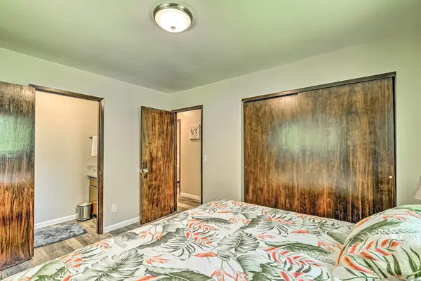 Master bedroom with king bed and lots of natural light from the windows.