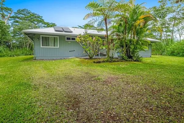 Escape to a private tropical backyard oasis surrounded by lush Hawaiian landscaping, swaying palms, and the peaceful beauty of paradise.