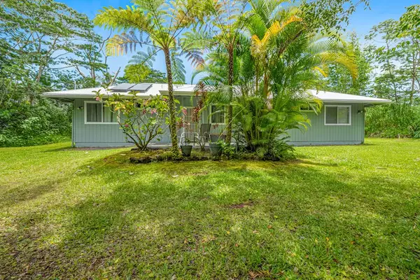 Escape to a private tropical backyard oasis surrounded by lush Hawaiian landscaping, swaying palms, and the peaceful beauty of paradise.