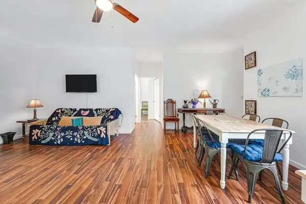 Large living room with a sofa bed and a flat screen tv.